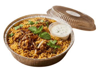 Chicken biryani with fried onions, fresh mint and raita in a takeout container